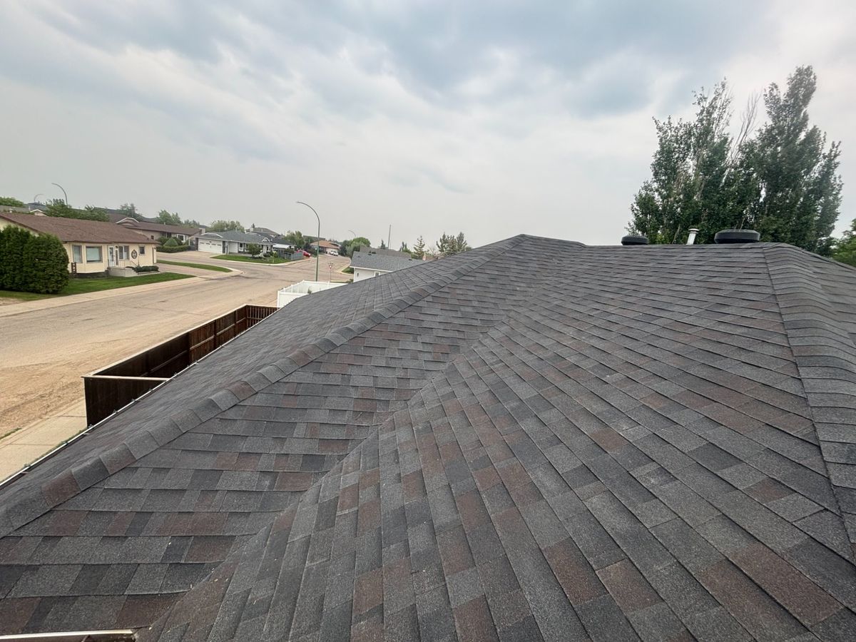 Dark architectural shingle roof completed in a Yorkton Saskatchewan neighbourhood by Molnar Roofing