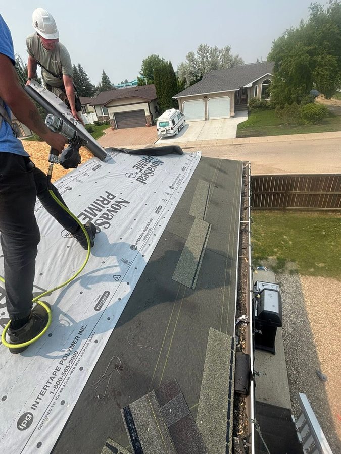Molnar Roofing crew member nailing architectural shingles over NovaSeal Prime underlayment in Yorkton Saskatchewan