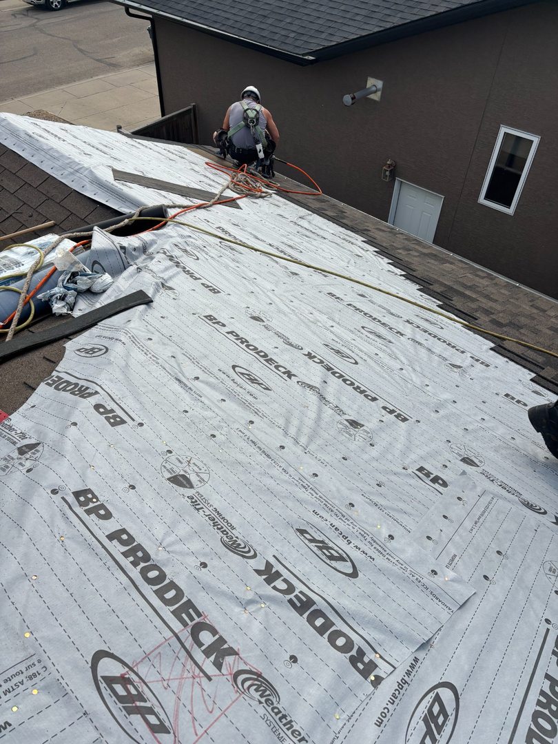Professional crew working on insurance claim roof replacement in Yorkton
