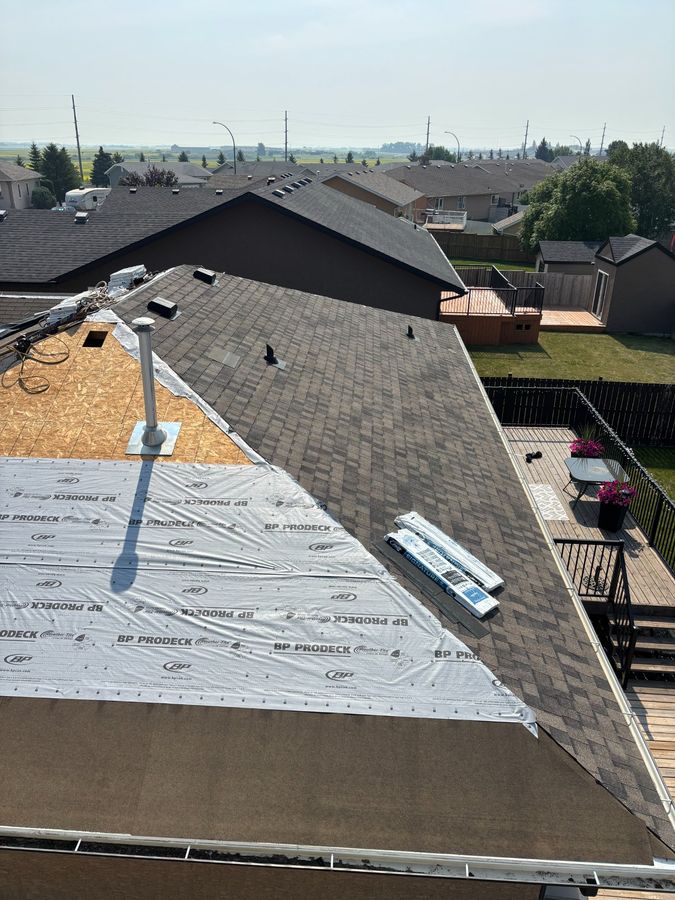 Roof replacement in progress showing BP ProDeck underlayment and new shingles being installed in Yorkton Saskatchewan