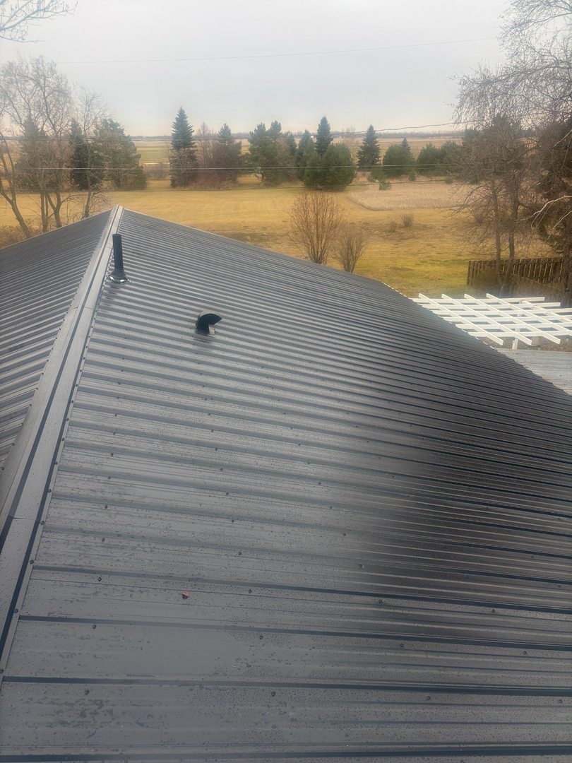 Completed metal roof with prairie landscape near Theodore Saskatchewan
