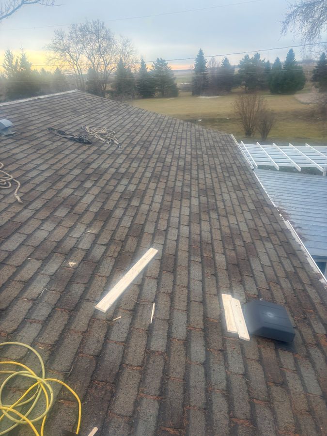 Worn and aging 3-tab shingles showing signs of deterioration needing replacement in Saskatchewan
