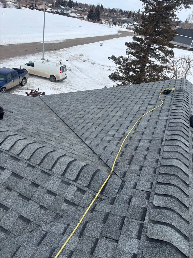 Completed roof replacement in winter with snowy neighbourhood near Ebenezer Saskatchewan