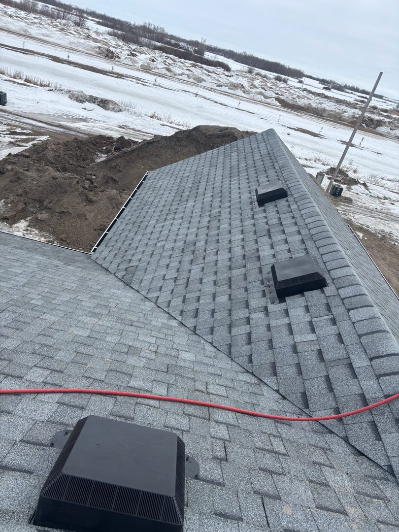 Winter new construction roofing with box vents and snowy prairie near Rhein Saskatchewan